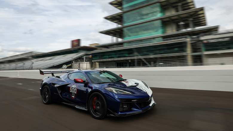 The half blue, half white with red accents livery for the 2027 Chevrolet C8 Corvette Pace Car of the 110th running of the Indianapolis 500 runs across the bricks in front of the Pagoda at Indianapolis Motor Speedway.