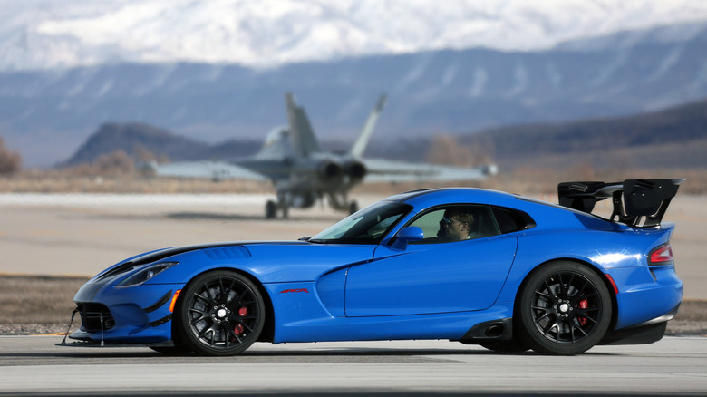 The only way this image of a blue Dodge Viper ACR on a runway with an E/A-18G Growler plane in the background could get any more American, is if the Viper was in a red, white, and blue paint scheme.