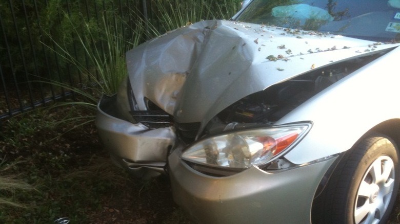 close up of the front of a silver 2002 Camry that just crashed into a tree