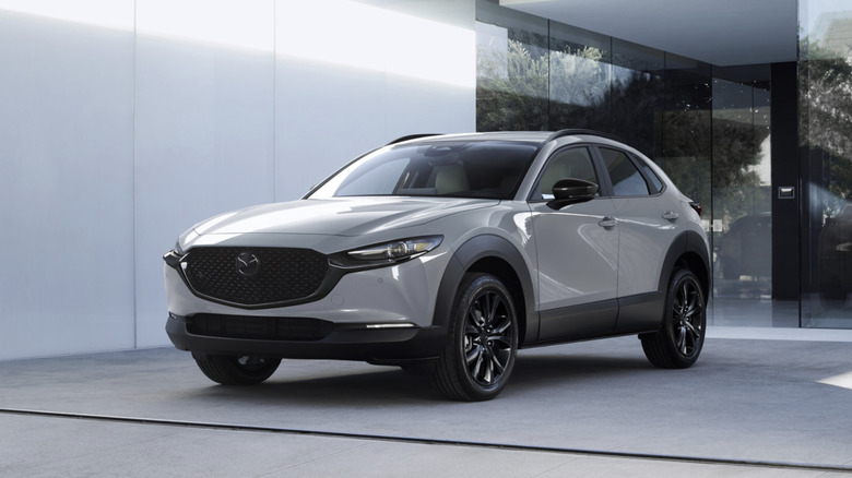 a Mazda CX-30 parked in front of a glass wall