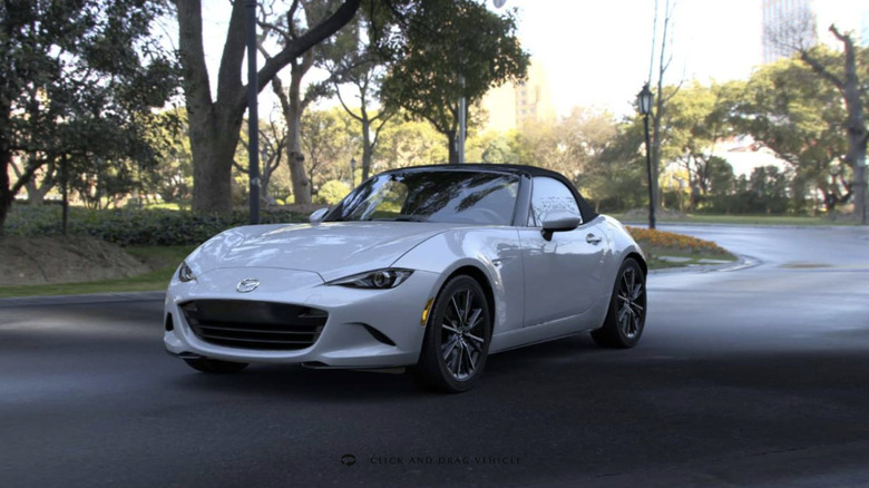 madza miata driving through the woods