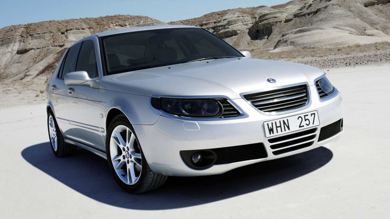 Silver Saab 9-5 parked in a white sands desert