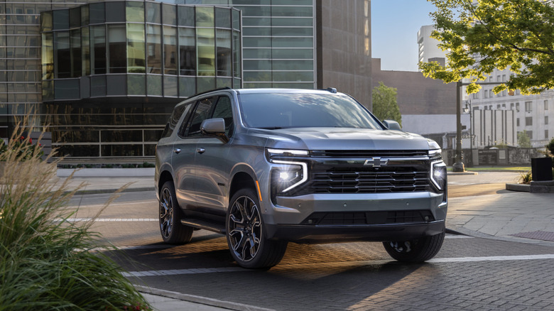 The 2026 Chevrolet Tahoe RST pulls through a vacant intersection in what appears to be a city of sorts.