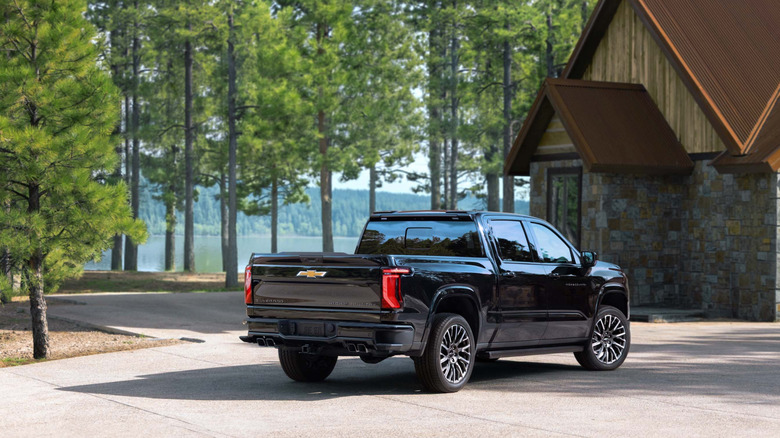 A black 2027 Chevrolet Silverado that looks pretty for the driveway it is parked in, and not for truck stuff.