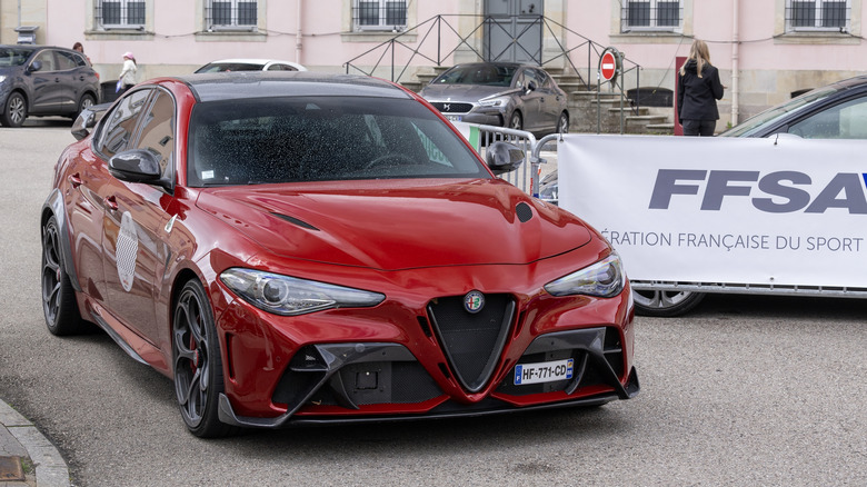 Remiremont, France - May 20th 2026 : View on a red Alfa Romeo Giulia GTA driving on a street. The Alfa Romeo Giulia is a compact executive car produced by the Italian manufacturer Alfa Romeo.