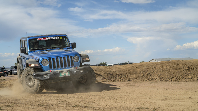 Loveland, CO, USA - August 27, 2022: Jeep Wrangler, Rubicon model, on a dusty training drive off-road course.