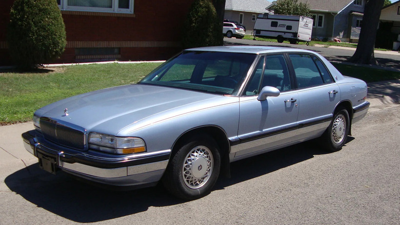A light blue 1994 Buick Park Avenue parked along a neighborhood street.