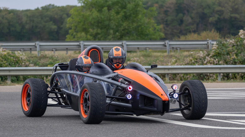 Nancy, France - September 22nd 2019 : View on an orange and black Ariel Atom 300 Supercharged driving on a road.