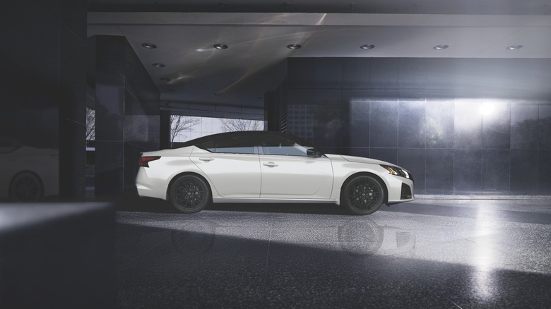 A white Nissan Altima from the side