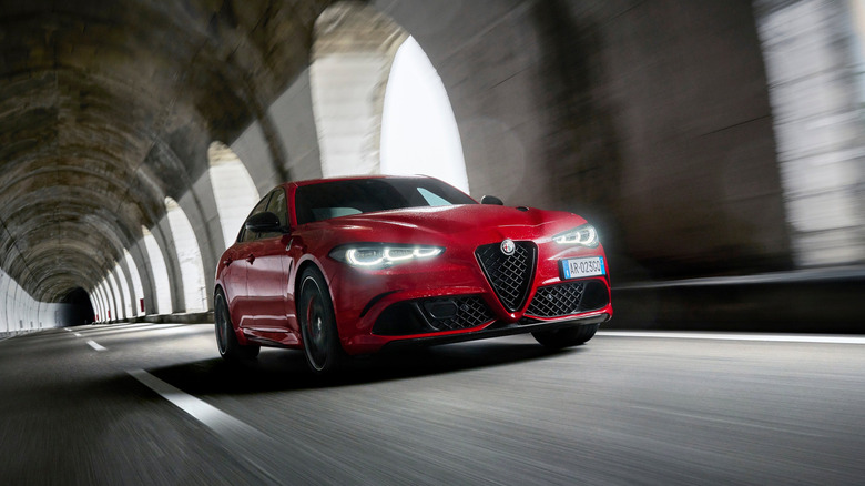 A red Alfa Romeo Giulia driving through a tunnel