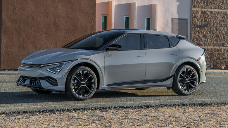 A dark gray Kia EV6 parked outside a building