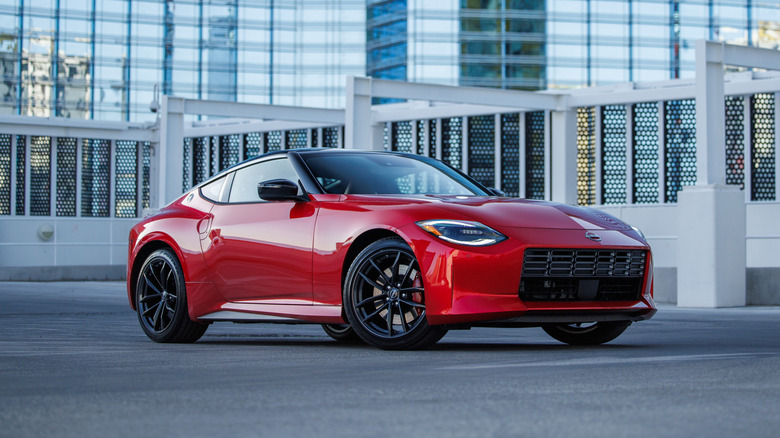 A red Nissan Z parked in a rooftop parking lot