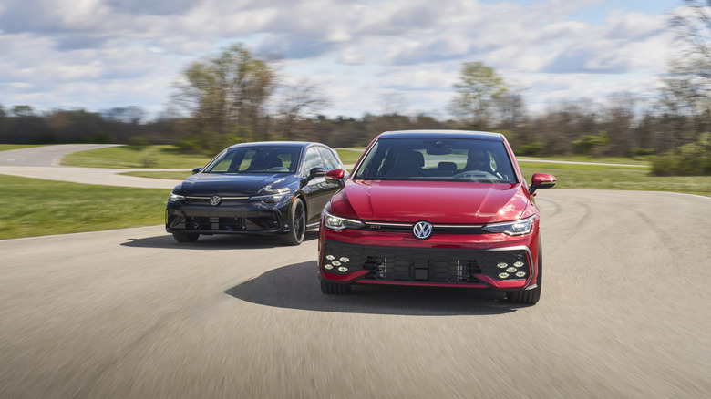 A pair of red and black Volkswagen Golf Rs racing around a club track