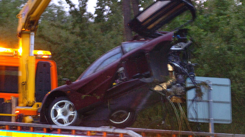 PETERBOROUGH, UNITED KINGDOM, AUGUST 4: (EMBARGOED FOR PUBLICATION IN UK UNTIL 0001, AUGUST 7, 2011) The McLaren F1 supercar of actor Rowan Atkinson is removed from the scene following a crash, August 4, 2011 in Peterborough, England. Atkinson pulled himself free and with nothing more than an injured shoulder after careering off the road. The car spun several times and smashed into a tree and road sign before catching fire on the opposite side of the carriageway. (Photo by Paul Franks / newsteam / Getty Images)