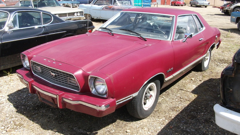 A red late 1970s Ford Mustang II