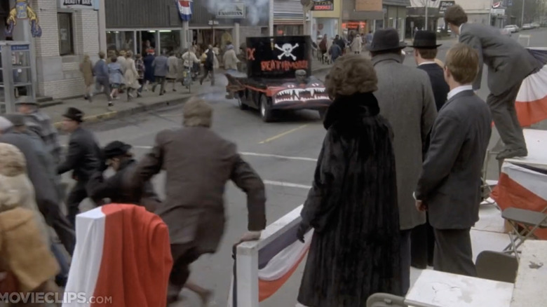 A scene from the movie Animal House where a death mobile drive through a parade