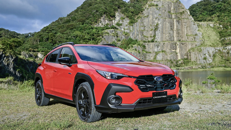 a subaru crosstrek parked in front of some rock formations