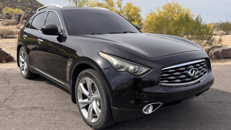a black Infiniti FX50S parked in a parking lot in the desert