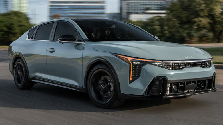 Front 3/4 action shot of a 2026 Kia K4