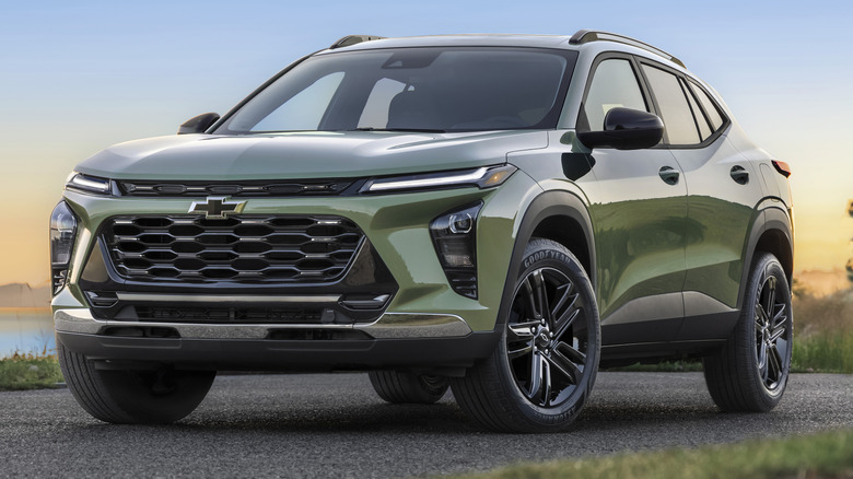 Cacti Green 2026 Chevrolet Trax parked on a road with a body of water in the background