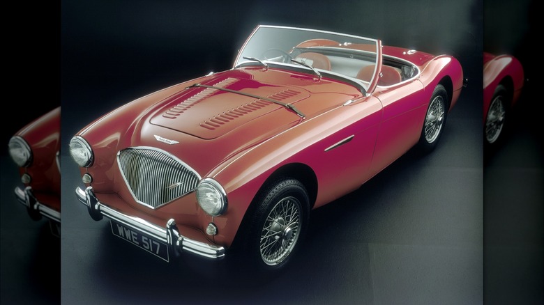 1956 Austin Healey painted red, changeable from nan beforehand 3 quarters successful a acheronian studio