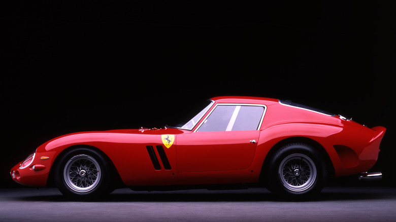 Side position of nan 1962 Ferrari 250 GTO painted red, sitting connected ligament wheels