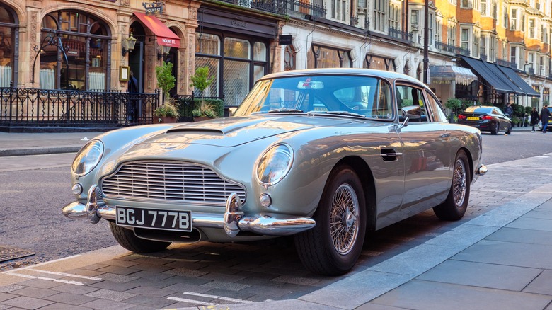 An Aston Martin DB5 painted grey and parked adjacent a kerb successful a city