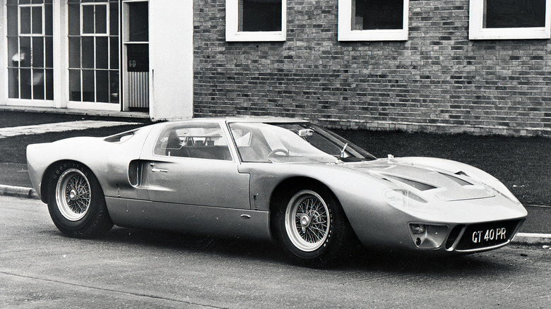 1965 Ford GT40 on wire wheels. Black-and-white picture. Car has "GT 40 PR" registration plate