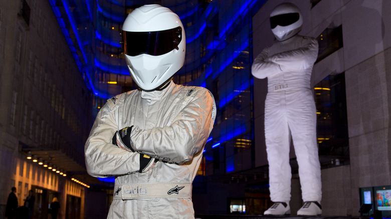 The Stig poses next to a giant statue of The Stig during a photocall to advertise the new series of the BBC's Top Gear programme at BBC Broadcasting House on May 17, 2016 in London, England. Photo by Ben A.