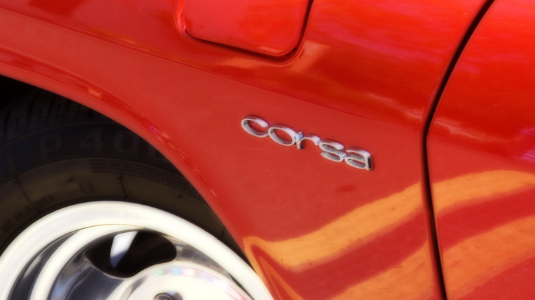 A close-up on the corsa badging on the front panel of a red Chevrolet Corvair Corsa