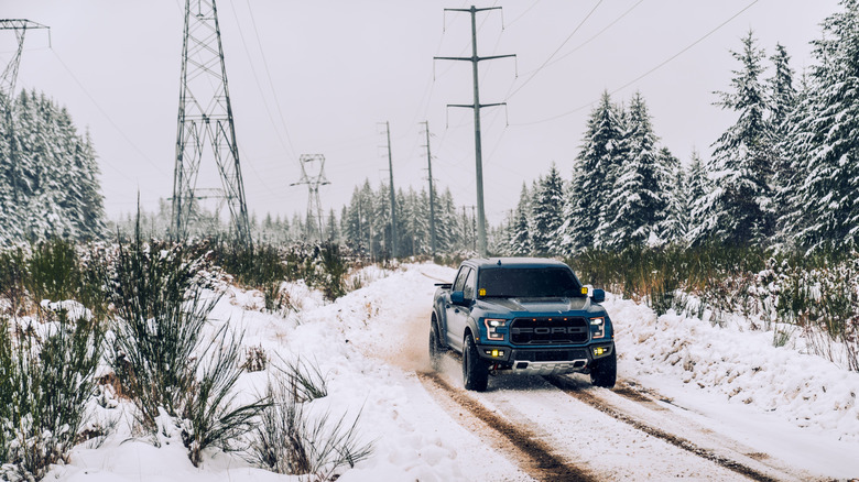 North Bend, WA, USA1/19/2022Ford Raptor driving in the snow with power lines in the background