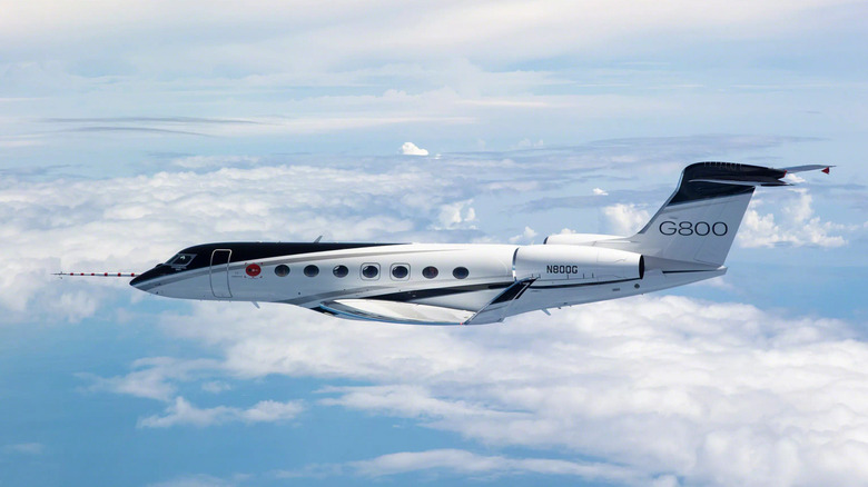 A Gulfsteam G800 in flight above clouds
