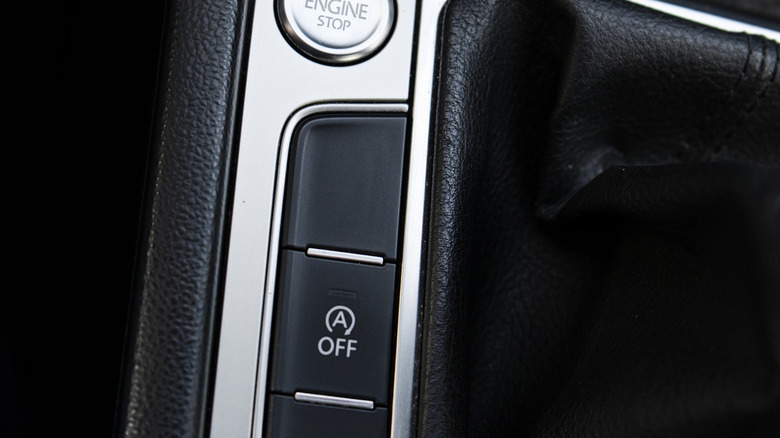 The auto/stop start button on the center console of a vehicle.