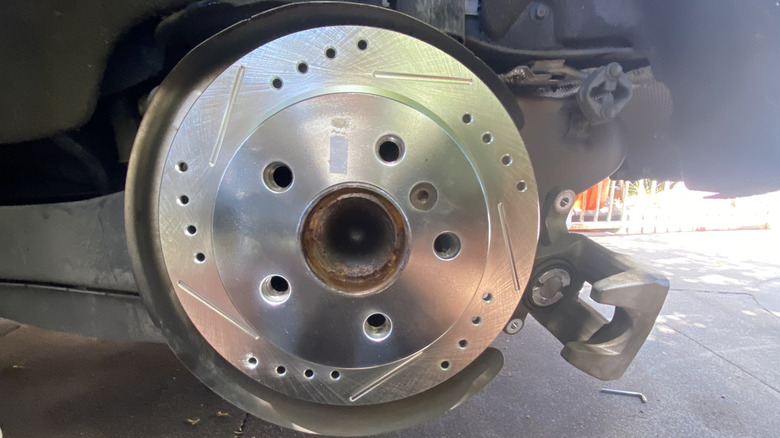 A brand new slotted and drilled brake disc on the rear of my Mini Cooper