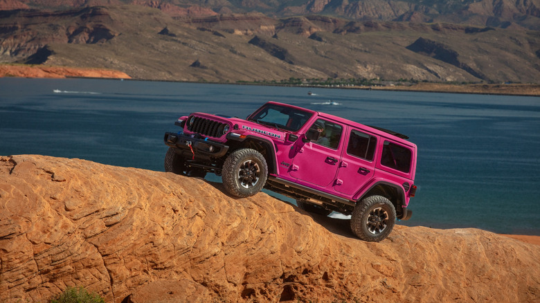 A beautiful pink 2024 Jeep Wrangler 4xe Rubicon on some cliff face.