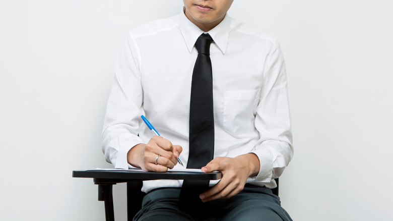 A Chinese man taking a written exam