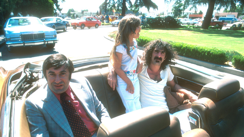 Frank Zappa in the backseat of a convertible car