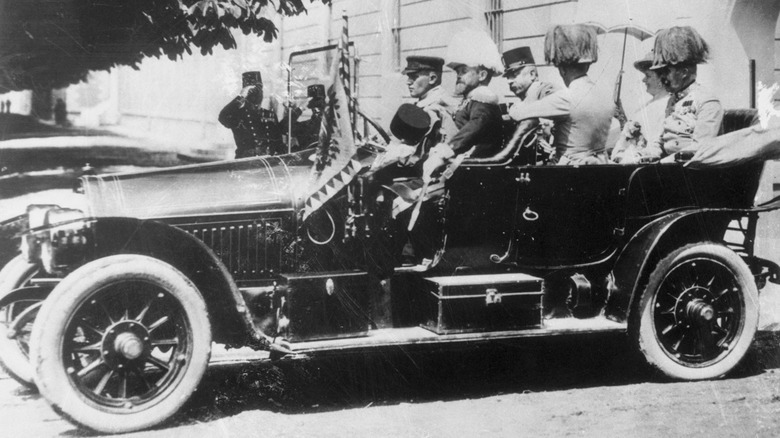 A black and white image of Archduke Franz Ferdinand sitting in an open-topped car