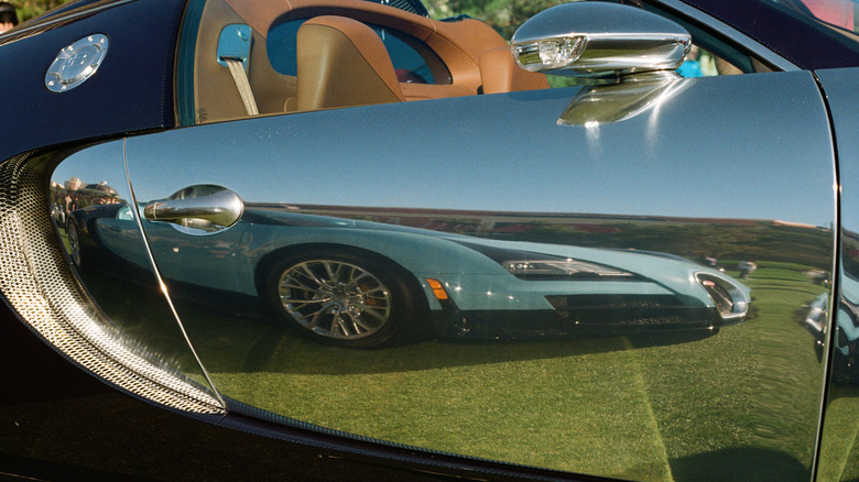 A Bugatti Veyron reflected in the door panel of another Bugatti Veyron