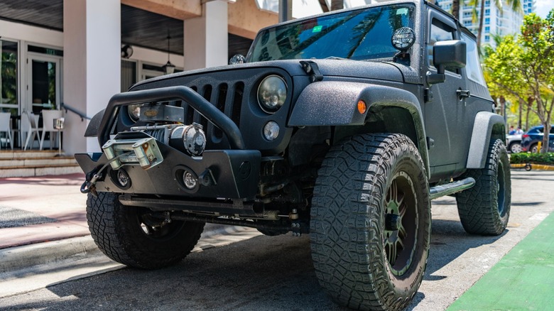 a Jeep Wrangler parked in front of a business