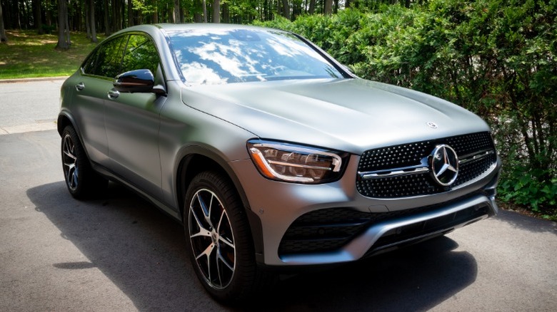 a silver mercedes-benz vehicle parked in a driveway