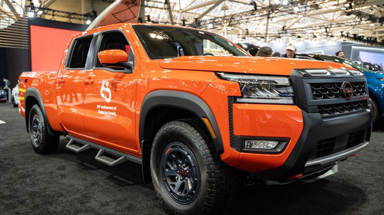 an orange 2025 Nissan Frontier parked indoors