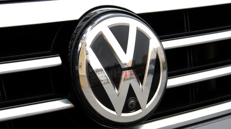 Extreme closeup of the front of a Volkswagen badge on the car's grille
