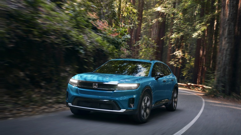 Front 3/4 of 2025 Honda Prologue driving through forest