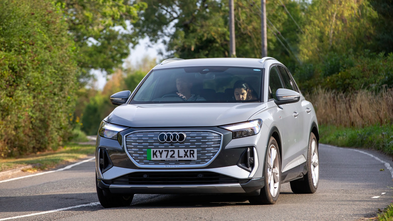 A Audi Q4 e-tron drives on a curve.