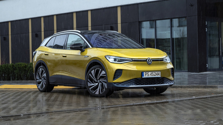 A yellow Volkswagen ID.4 sits parked.