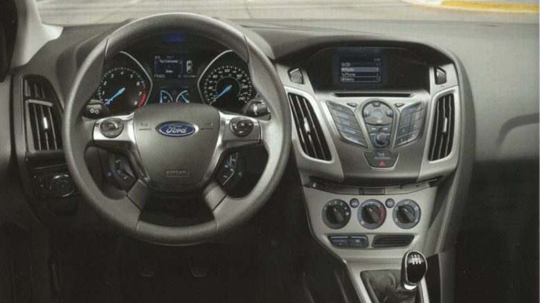 A display of a 2014 Ford Focus interior, complete with buttons and knobs everywhere.