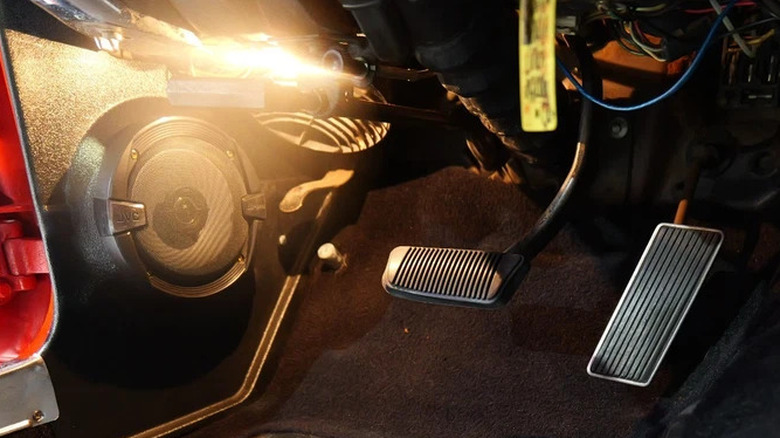 Follow the light, which happens to illuminate the high-beam floor switch and the wiper pedal on a 1967 Ford Mustang.