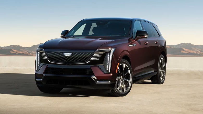 2026 Cadillac Escalade IQ on a sandy road by mountains