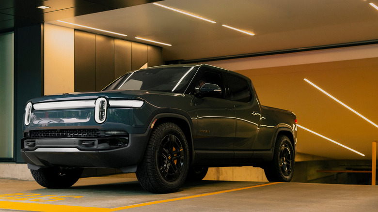 2026 Rivian R1T driving out of a parking garage